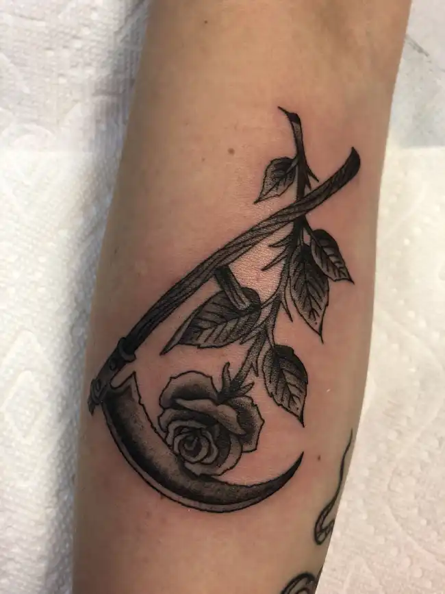 What Is the Meaning Behind a Scythe and Rose Tattoo?